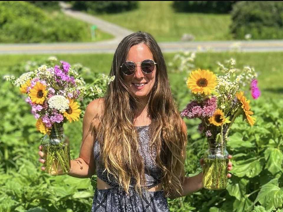 Second Drop Farm owner photo in a flower field